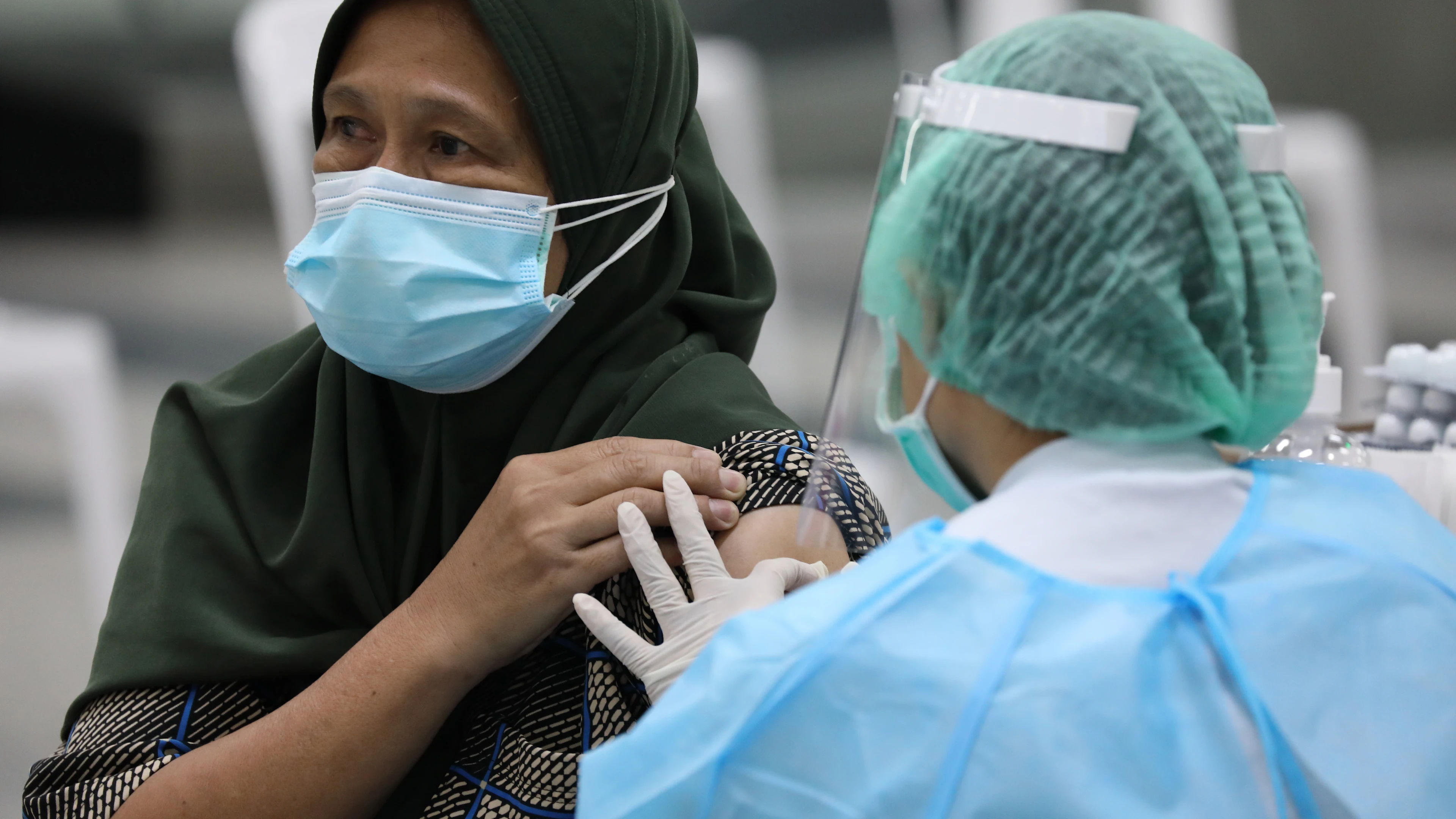 Lady after injected with a vaccine by a nurse in Thailand.
